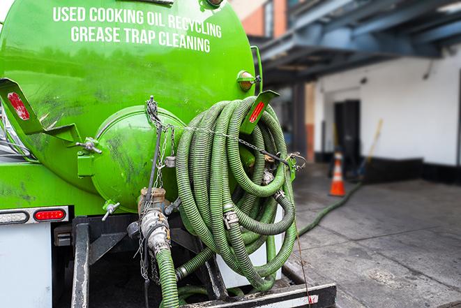 large truck pumping grease trap at a restaurant in Lauderhill, FL